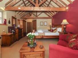 A bedroom with a bed and wooden furnishings at Champagne Cottage in Malton
