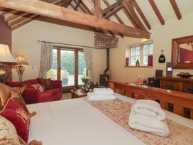 A bedroom with a bed and a fireplace at Champagne Cottage in Malton