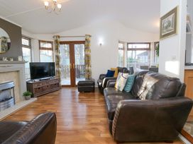 A living room with a television and seating area at 6 Waterside Windermere