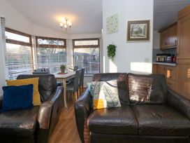 A snug area with a sofa and dining table at 6 Waterside Windermere