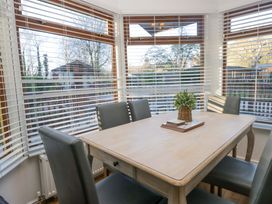 A dining room with a table and chairs at 6 Waterside in Windermere