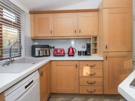 A kitchen with cabinets and appliances at 6 Waterside in Windermere