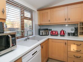 A kitchen with a sink and appliances at 6 Waterside in Windermere