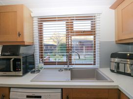 A kitchen with a sink and window at 6 Waterside in Windermere