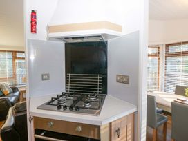 A kitchen space with a gas stove and extraction hood at 6 Waterside Windermere
