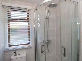 A bathroom with a shower and toilet at 6 Waterside in Windermere