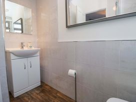 A bathroom with a sink and mirror at 6 Waterside in Windermere