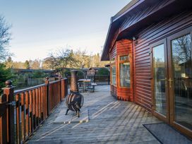 An outdoor area with a chiminea and furniture at 6 Waterside Windermere