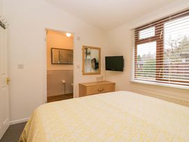 A bedroom with a bed and television at 6 Waterside, White Cross Bay near Windermere