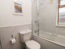 A bathroom with a shower and bathtub at 6 Waterside, White Cross Bay near Windermere
