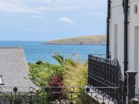 View of ocean and island with a flag at Angorfa Apartment Abersoch