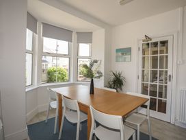 A dining room with a table and chairs at Angorfa Apartment in Abersoch
