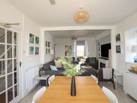 A dining area with a table and chairs at Angorfa Apartment in Abersoch