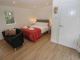 A bedroom with a bed and couch at Heidiaway Lodge Porth