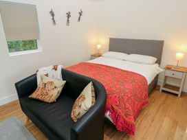 A bedroom with a bed and sofa at Heidiaway Lodge in Gilfach Goch
