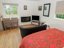 A living room with a bed and furniture at Heidiaway Lodge in Gilfach Goch