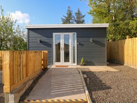 An outdoor view of a cabin entrance at Heidiaway Lodge in Gilfach Goch