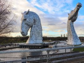 Two large horse sculptures by the water at Beechtree Timber Lodge 69B Denny