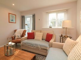 A living room with a sofa and armchair at Blackstone Cottage in Salcombe