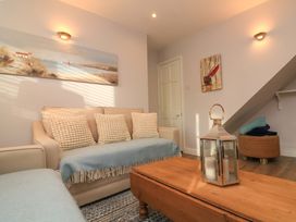 A living room with a sofa and coffee table at Blackstone Cottage in Salcombe