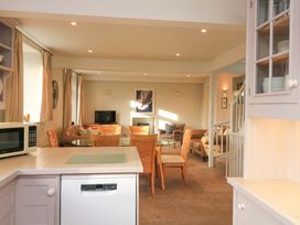 A kitchen with dining area and living space at Blackstone Cottage in Salcombe