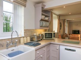 A kitchen with appliances and countertop at Blackstone Cottage Salcombe