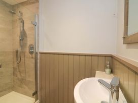 A bathroom with a shower and sink at Blackstone Cottage in Salcombe