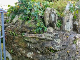 A sign reading Blackstone Cottage on a rock face with ivy at Blackstone Cottage in Salcombe