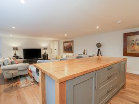 A living room with a television and couches at Flat 6
