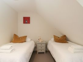 A bedroom with two beds and a nightstand at Flat 6 in 