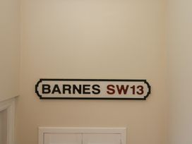 A sign displaying BARNES SW13 in an indoor setting at Flat 6