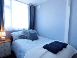 A bedroom with a bed and bedside table at 226 Third Avenue in Bridlington