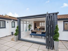 A dining area with sliding doors and potted plants at 6 Tegafan Abergele