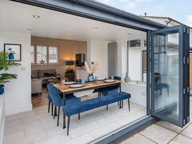 A dining room with a table and chairs at 6 Tegafan Abergele