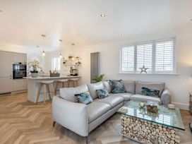 A living room with a sofa and coffee table at 6 Tegafan in Abergele