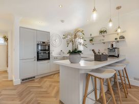 A kitchen with cabinets and a coffee machine at 6 Tegafan Abergele