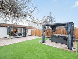 A garden with a hot tub and paved patio at 6 Tegafan Abergele