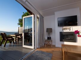 A sitting room with a television and fireplace at Nethermill Lodges in Port Glasgow