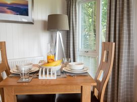 A dining table with tableware at Nethermill Lodges in Port Glasgow
