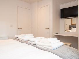 A bedroom with towels on a bed at Nethermill Lodges in Port Glasgow