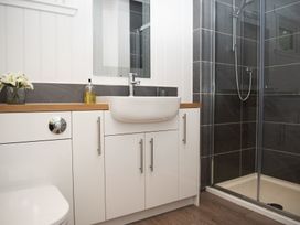A bathroom with a shower and sink at Nethermill Lodges in Port Glasgow