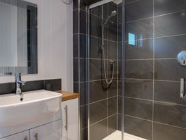 A bathroom with a sink and shower at Nethermill Lodges Port Glasgow