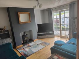 A living room with a fireplace and television at 17 Castleview in Ballymena