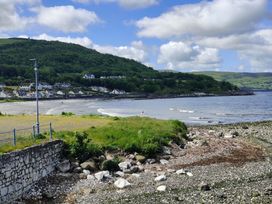 A beach view with rocks and houses near the sea at 17 Castleview in Ballymena