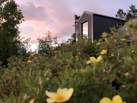 A building with a window surrounded by plants and flowers at Cullinview Isle of Skye
