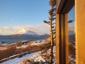A view of a mountain and lake from a window at Cullinview in Isle of Skye