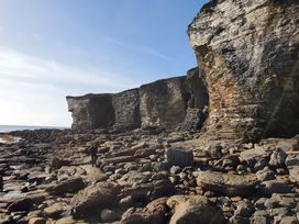 A landscape with cliffs and rocks near the ocean at Cullinview Isle of Skye