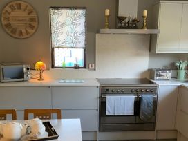 A kitchen with a stove and microwave at Fenton Drive in Wooler