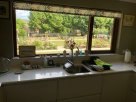 A kitchen with a sink and window overlooking the garden at Fenton Drive Wooler