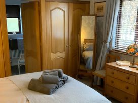 A bedroom with a bed and wardrobe at Fenton Drive in Wooler